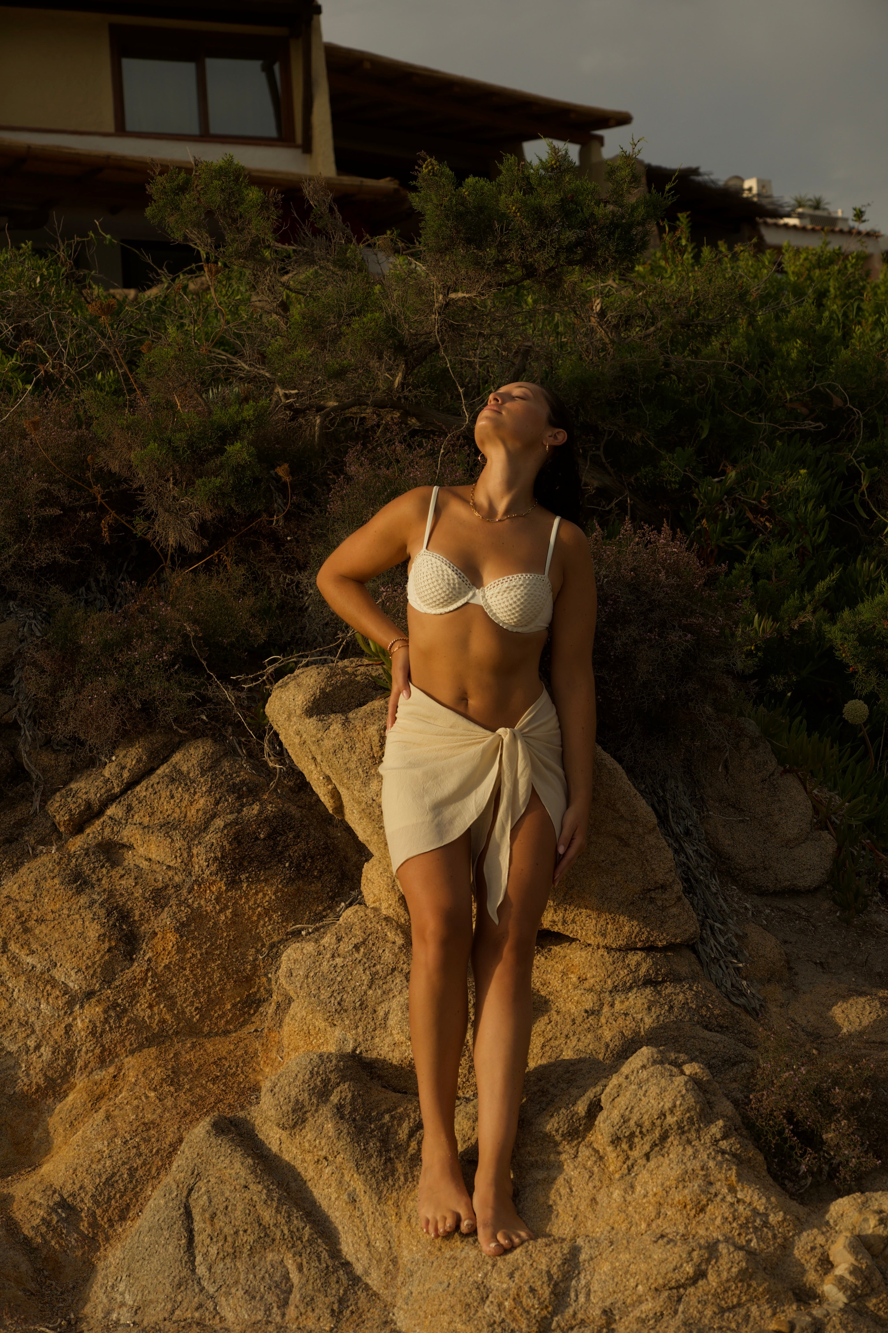 Chic beachwear look featuring model in pastel bikini by the ocean